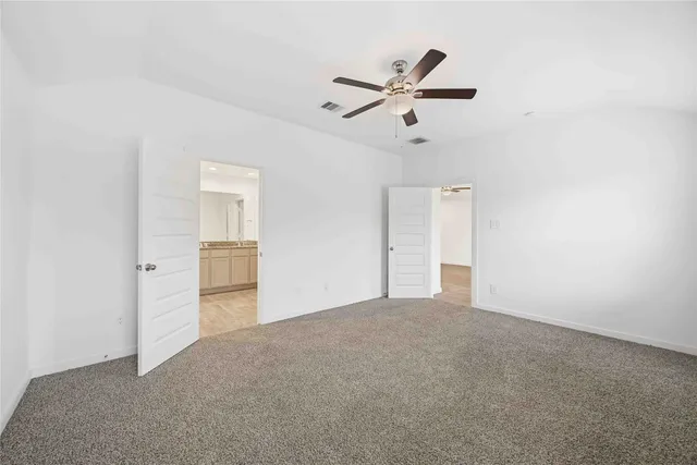 a view of a livingroom with a ceiling fan and window