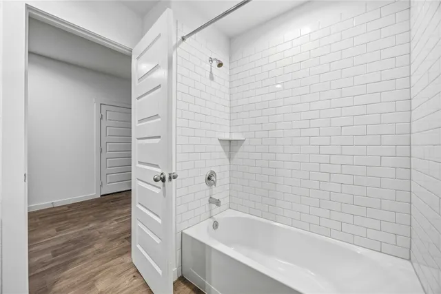 a bathroom with a bathtub and shower