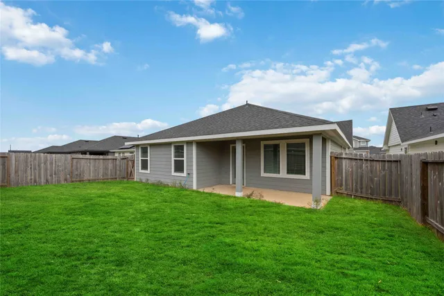 a front view of a house with yard and green space