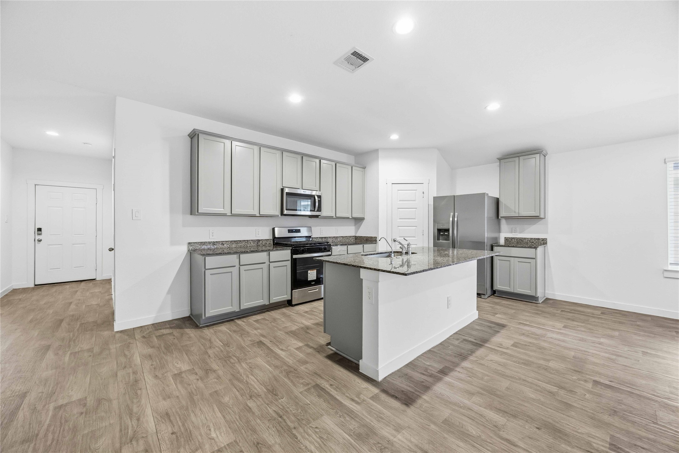 31627 Featherstone Trail Fulshear, TX 77441 - Photo 5 of 29 a kitchen with granite countertop white cabinets and stainless steel appliances