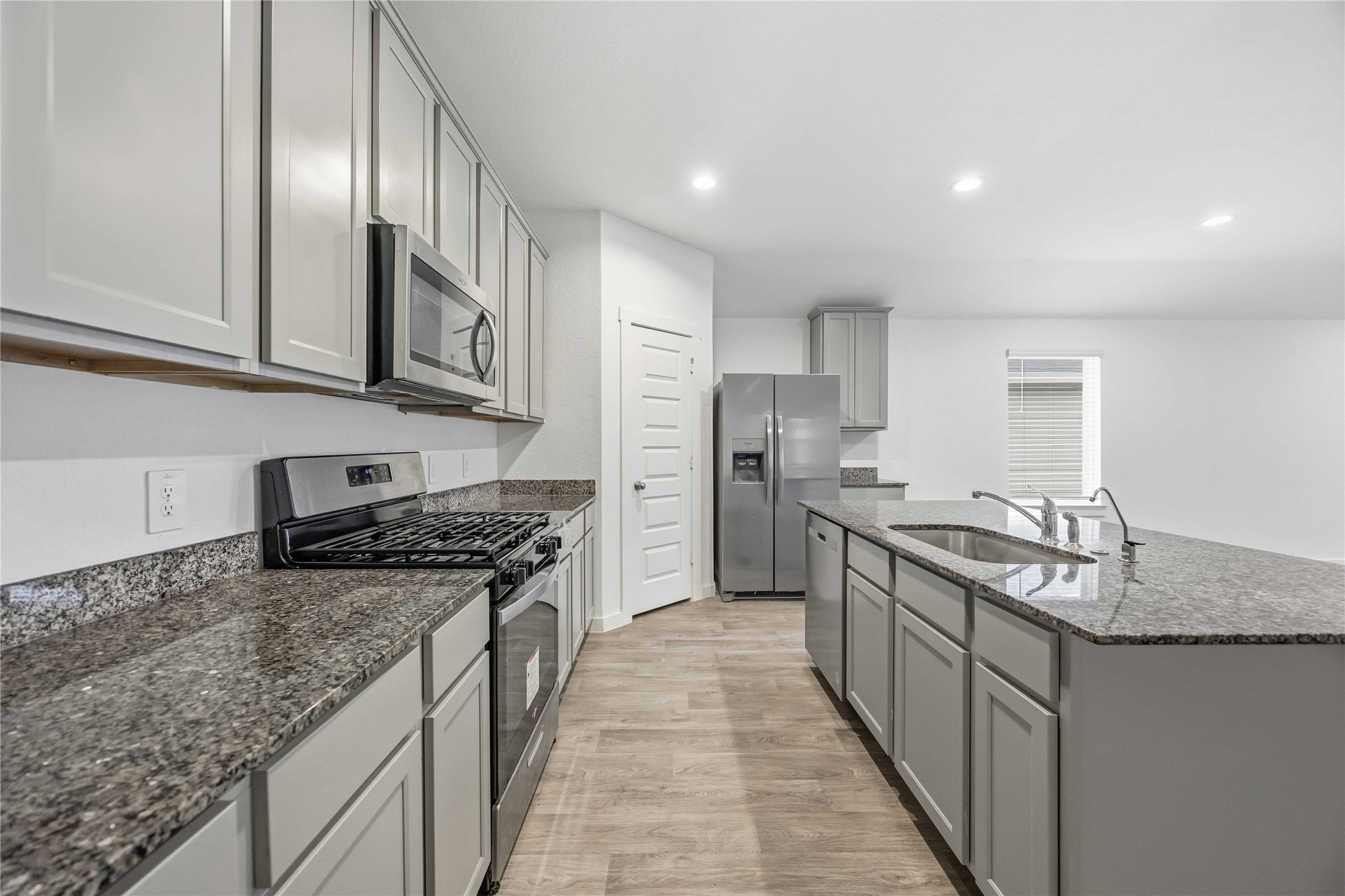 31627 Featherstone Trail Fulshear, TX 77441 - Photo 6 of 29 a kitchen with stainless steel appliances granite countertop a stove top oven a sink and dishwasher