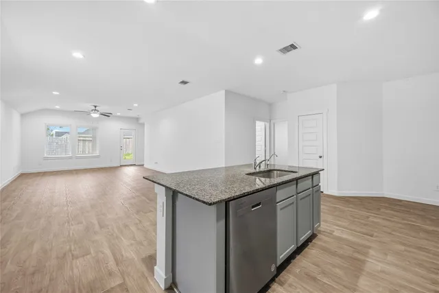 a kitchen with a sink and a stove top oven