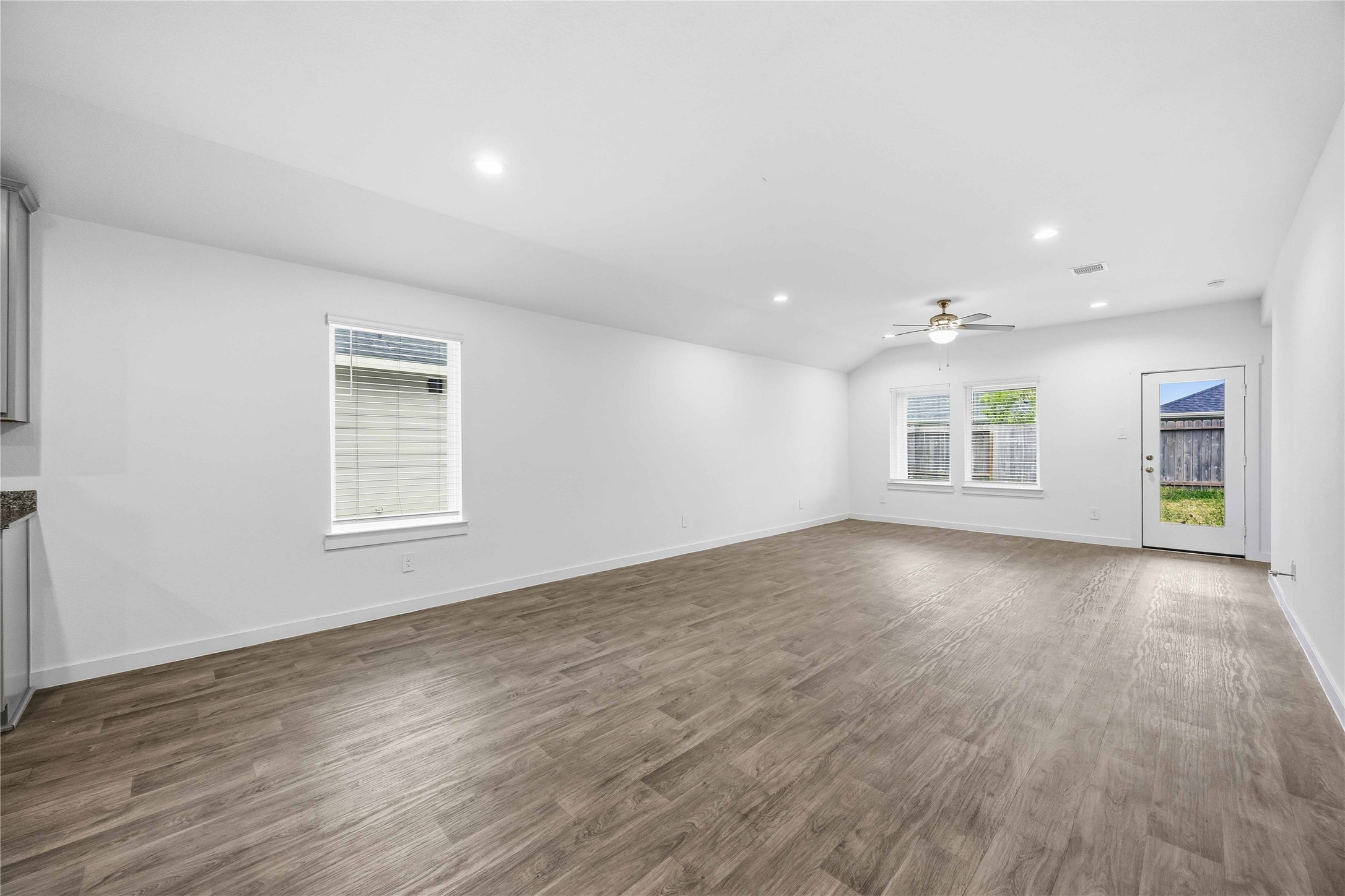 31627 Featherstone Trail Fulshear, TX 77441 - Photo 8 of 29 an empty room with wooden floor and windows