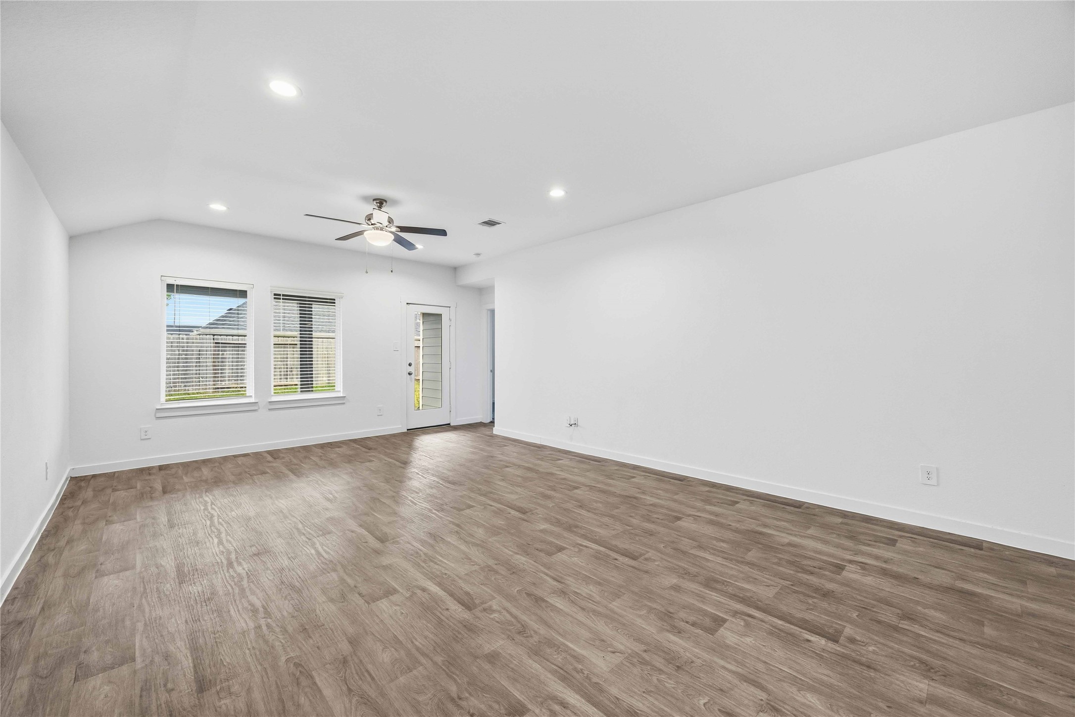 31627 Featherstone Trail Fulshear, TX 77441 - Photo 9 of 29 a view of an empty room with wooden floor and a window
