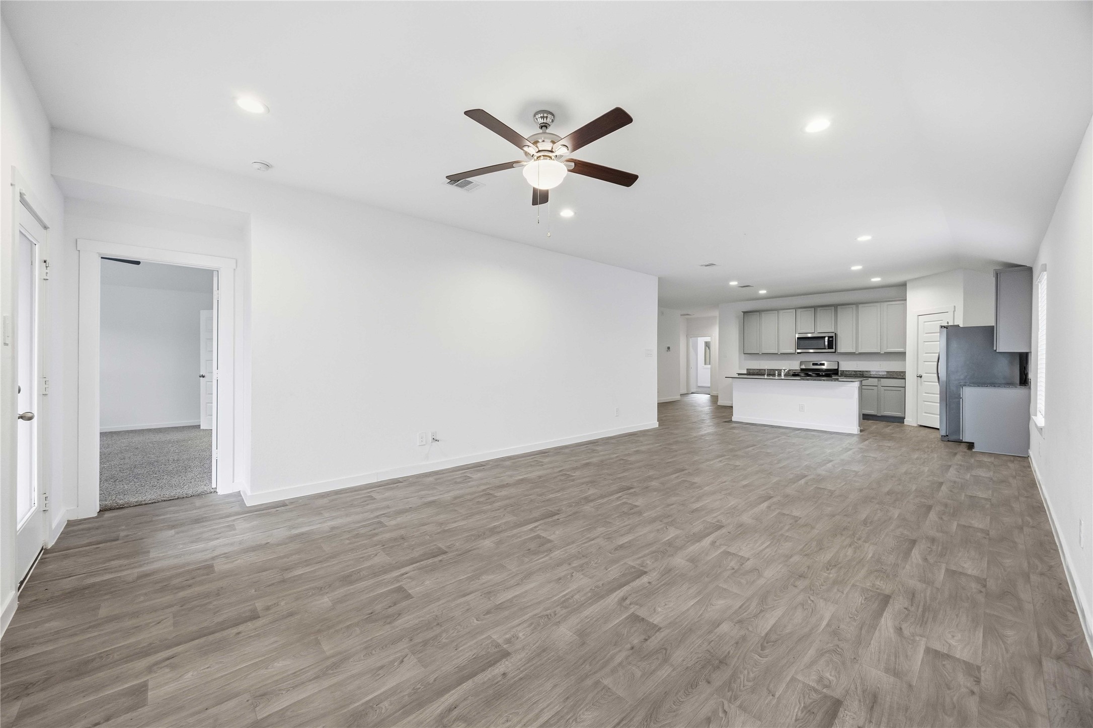 31627 Featherstone Trail Fulshear, TX 77441 - Photo 10 of 29 a view of a kitchen with a sink and dishwasher a refrigerator with wooden floor