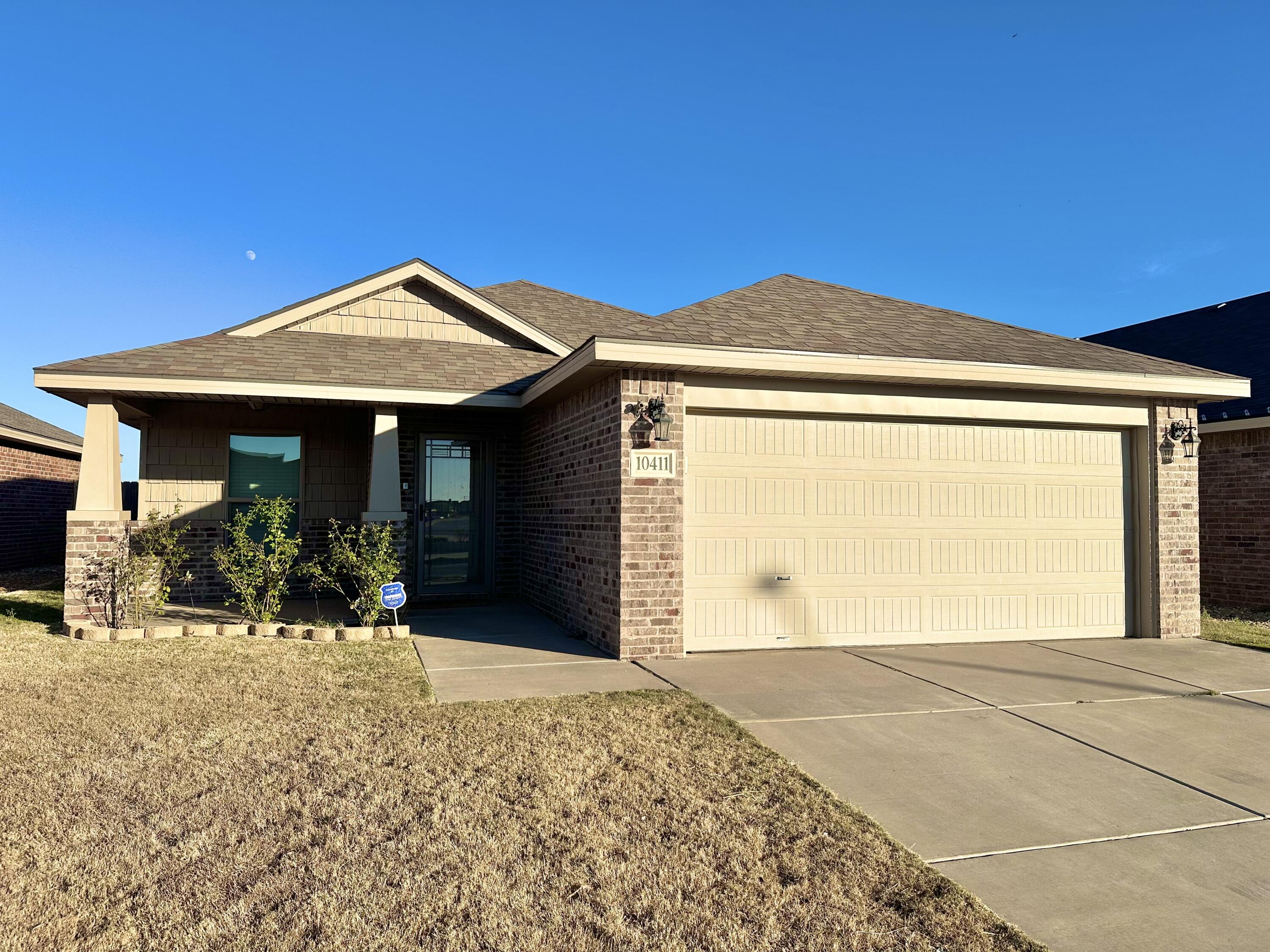10411 Valencia Avenue Lubbock, TX 79424 - Photo 1 of 16 a front view of a house with a yard