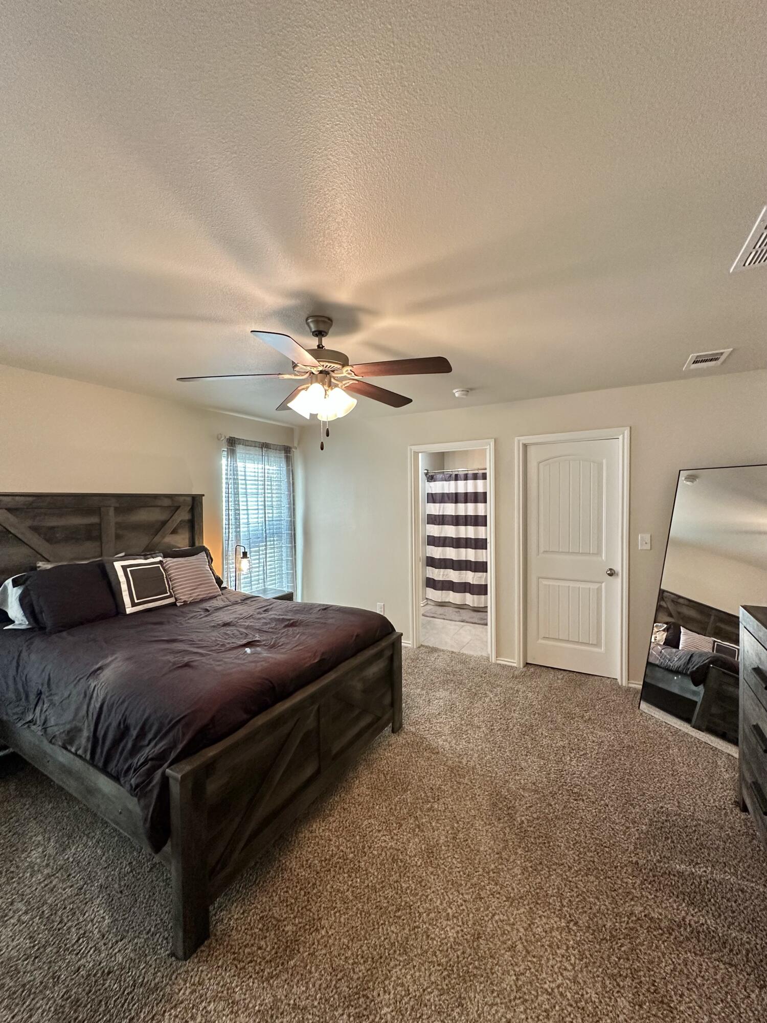 10411 Valencia Avenue Lubbock, TX 79424 - Photo 7 of 16 a bedroom with a bed and a ceiling fan