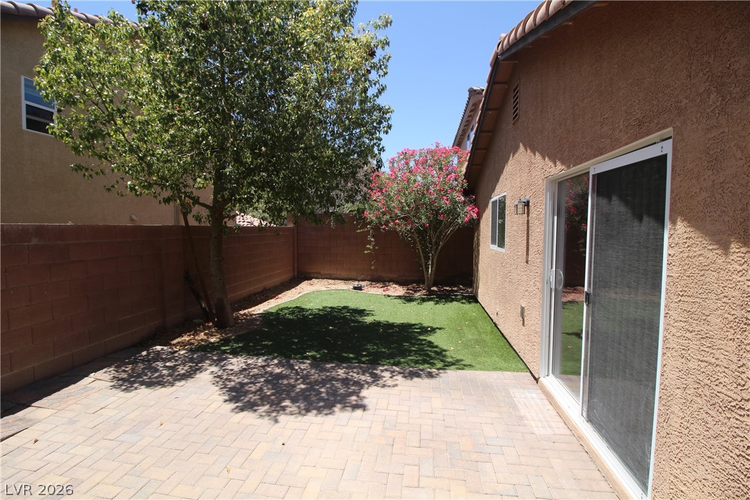 9289 Valley Ranch Avenue Las Vegas, NV 89178 - Photo 28 of 29 A private, low-maintenance outdoor haven with artificial turf and a generous paver patio.