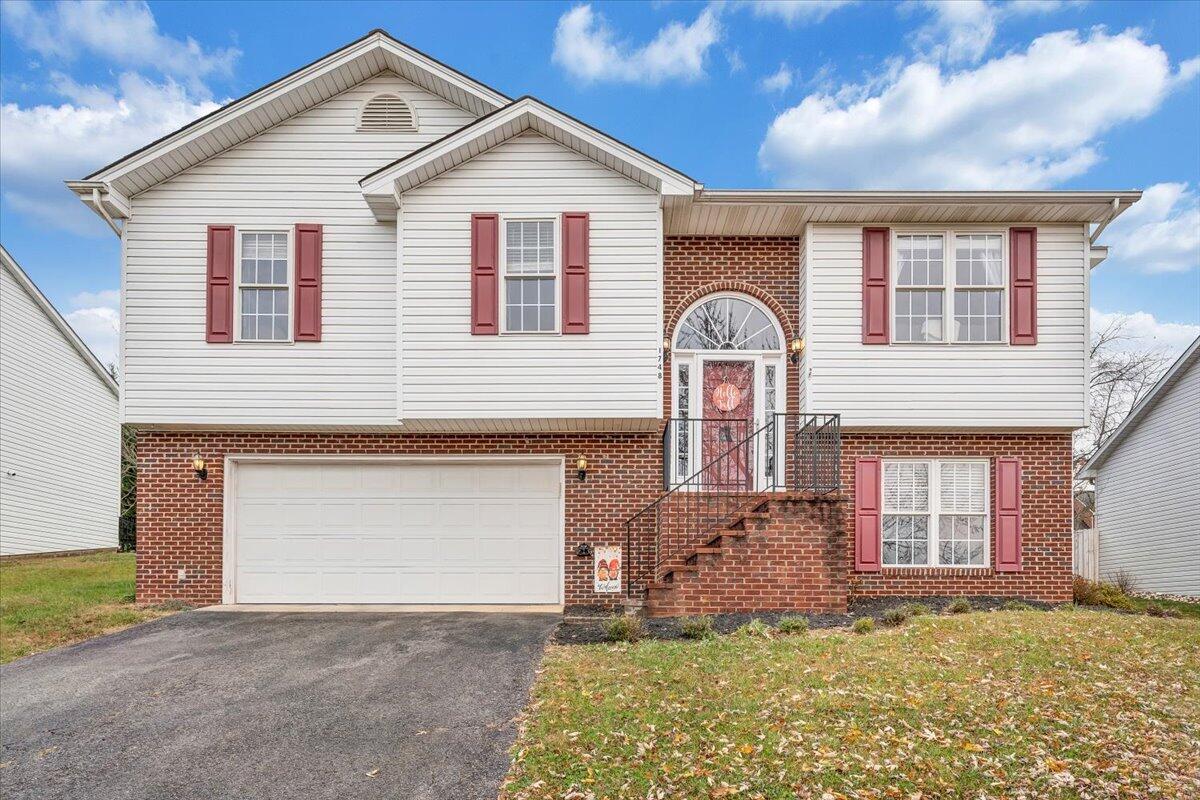 1748 Meadows Road Vinton, VA 24179 - Photo 1 of 34 a front view of a house with a yard and garage