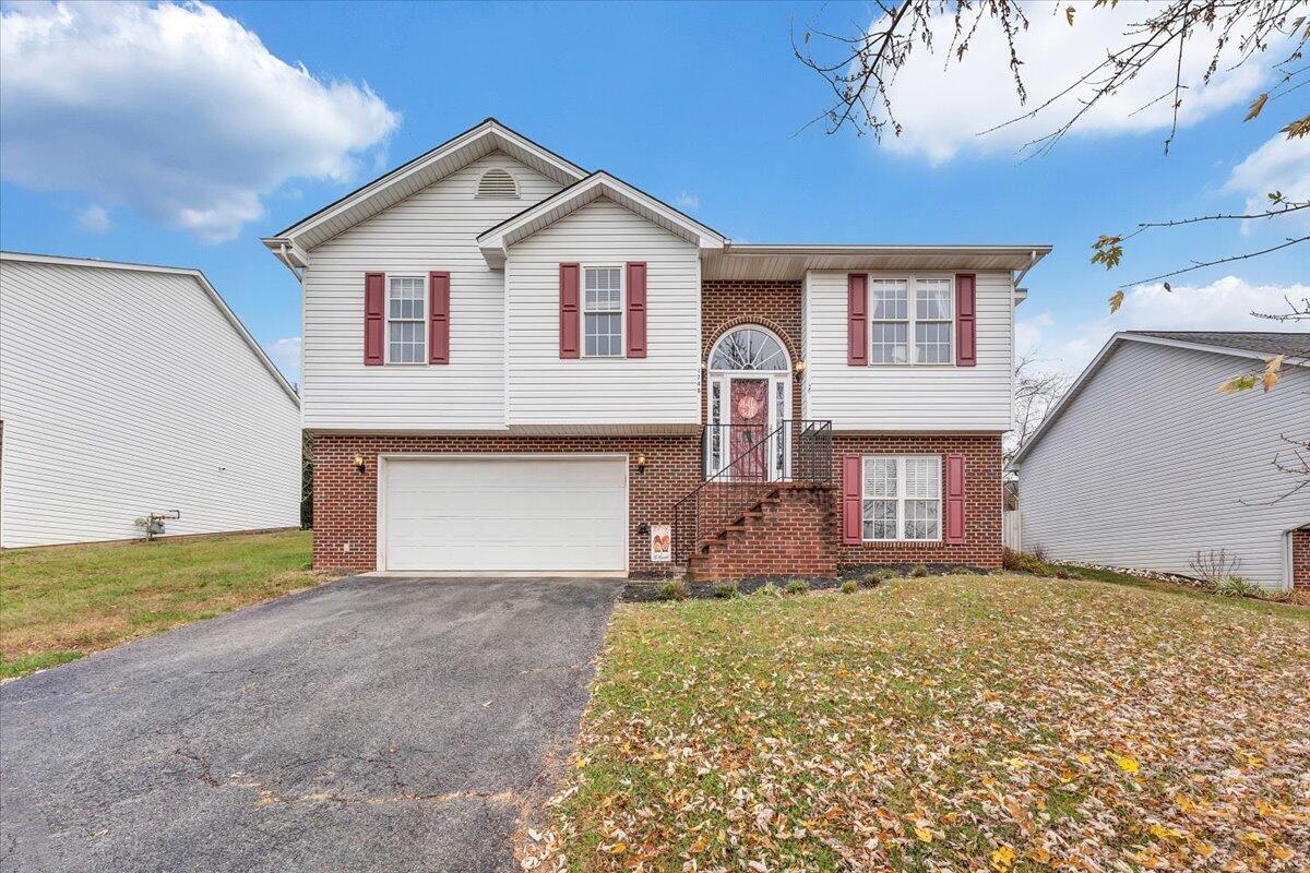 1748 Meadows Road Vinton, VA 24179 - Photo 2 of 34 a front view of a house with a yard and garage