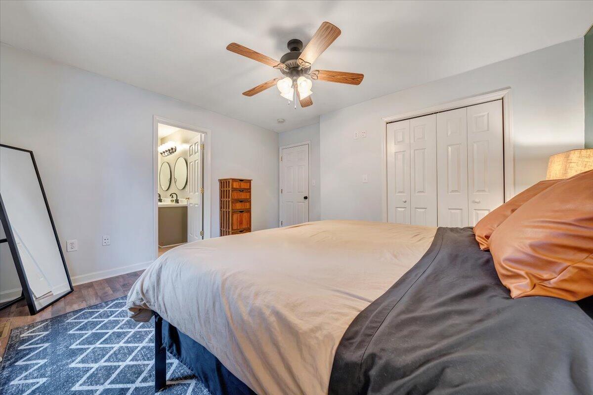 1748 Meadows Road Vinton, VA 24179 - Photo 21 of 34 a bedroom with a large bed and a chandelier