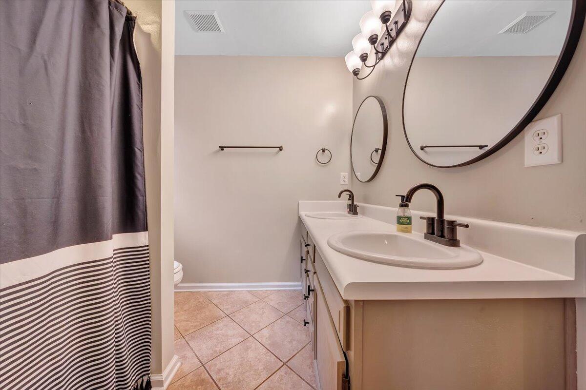 1748 Meadows Road Vinton, VA 24179 - Photo 22 of 34 a bathroom with a sink and a mirror