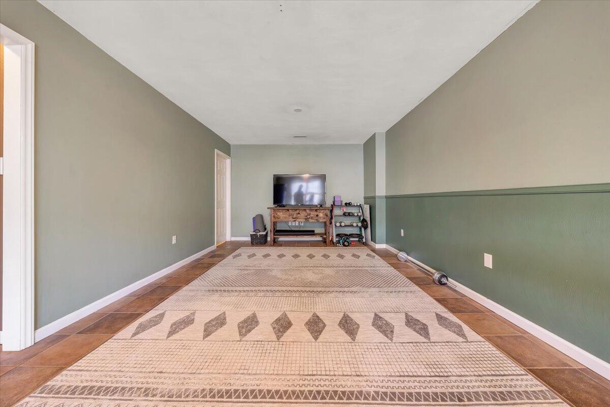 1748 Meadows Road Vinton, VA 24179 - Photo 25 of 34 a view of a bedroom with wooden floor and chair