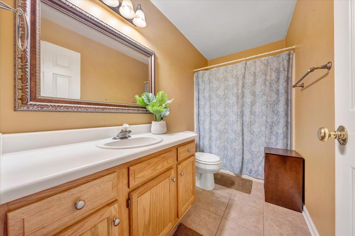 1748 Meadows Road Vinton, VA 24179 - Photo 26 of 34 a bathroom with a granite countertop sink and a mirror