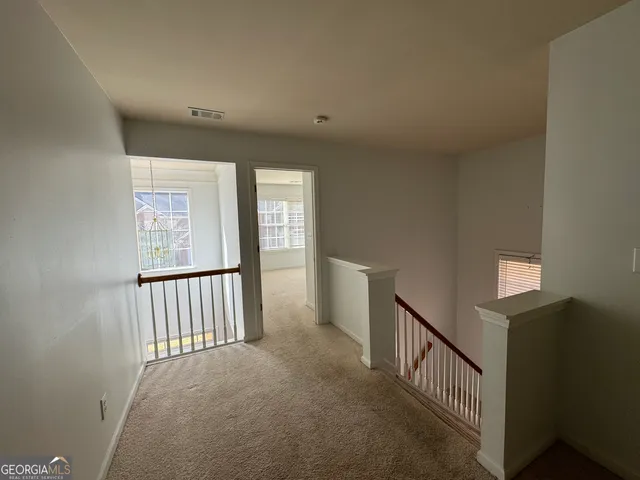a view of a hallway with windows