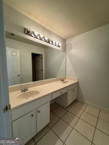 a spacious bathroom with a double vanity sink mirror and