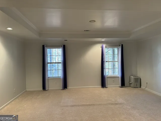 an empty room with windows and closet
