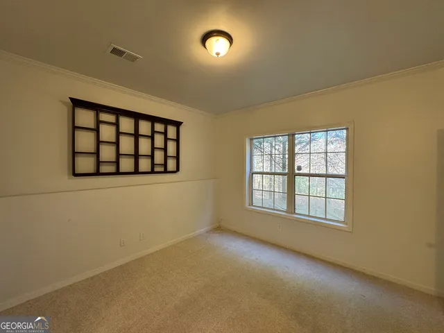 an empty room with a empty space and windows