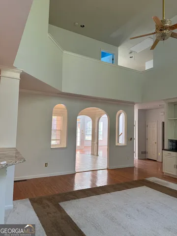 a view of entryway and hall with wooden floor