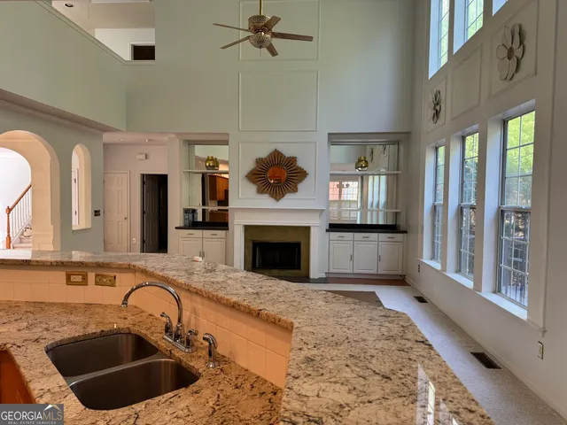 a kitchen with a sink and a fireplace