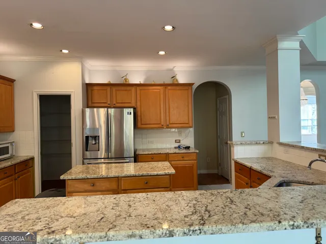 a view of a living room and kitchen view