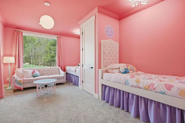 a view of a hallway with wooden floor and a living room