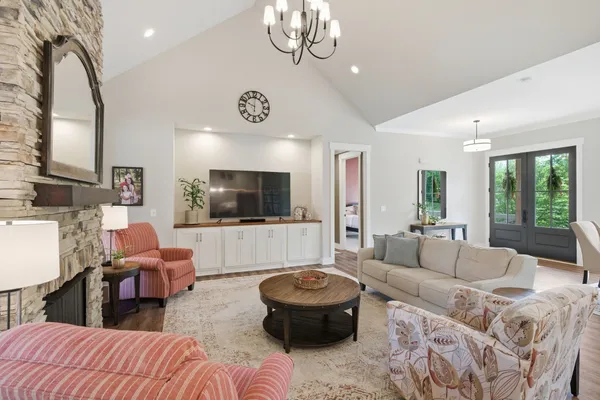 a kitchen with granite countertop a stove a refrigerator and a dining table