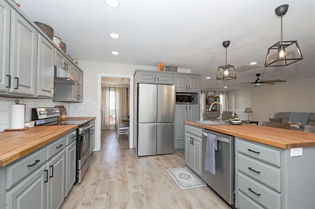 a kitchen with kitchen island granite countertop wooden cabinets and a refrigerator