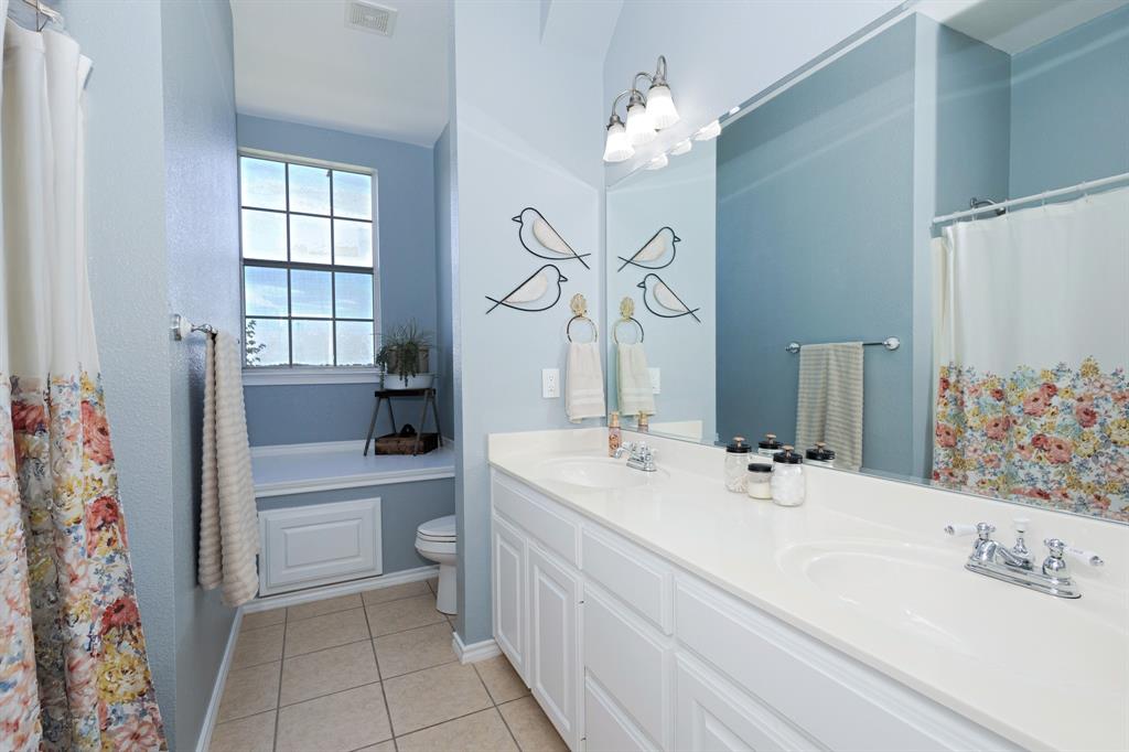 13508 Deussen Road Ponder, TX 76259 - Photo 26 of 40 a bathroom with a sink a toilet and shower