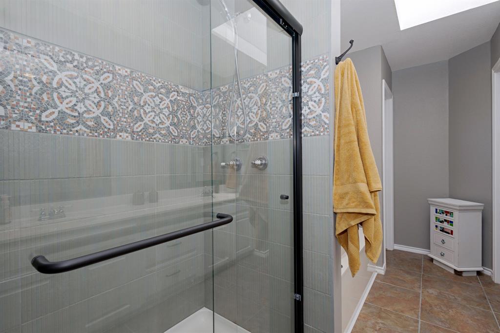 13508 Deussen Road Ponder, TX 76259 - Photo 29 of 40 a bathroom with a granite countertop sink a mirror and shower