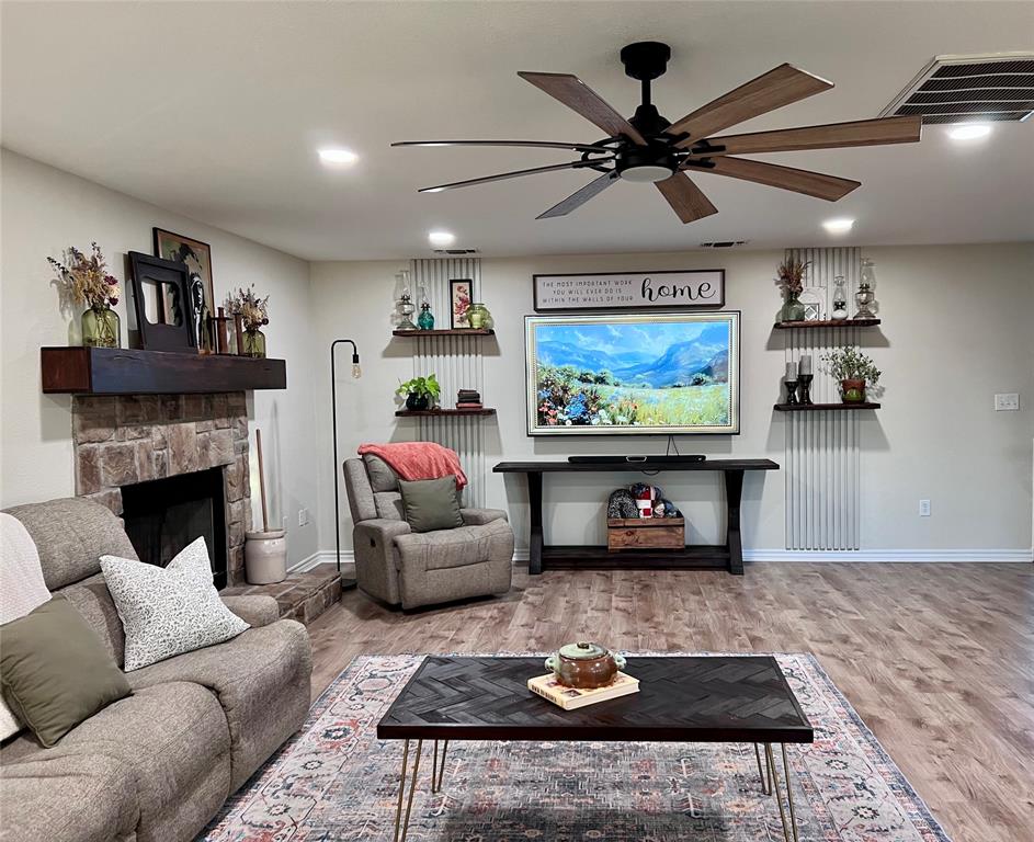 13508 Deussen Road Ponder, TX 76259 - Photo 5 of 40 a living room with furniture a rug and a fireplace