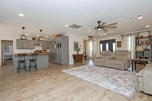 a living room with furniture and wooden floor