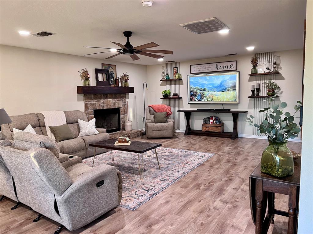13508 Deussen Road Ponder, TX 76259 - Photo 7 of 40 a living room with furniture a fireplace and a flat screen tv