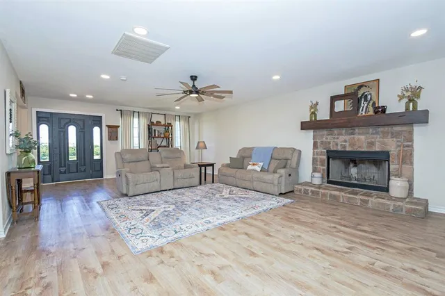 a living room with furniture and a fireplace