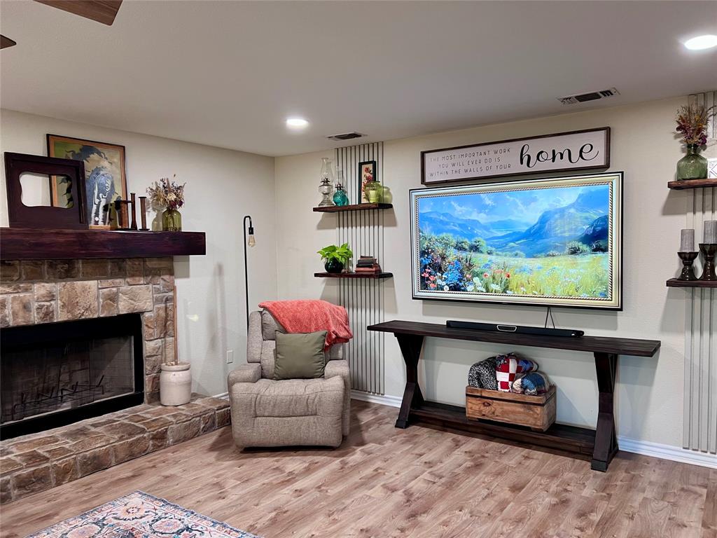 13508 Deussen Road Ponder, TX 76259 - Photo 8 of 40 a living room with furniture a flat screen tv and a fireplace