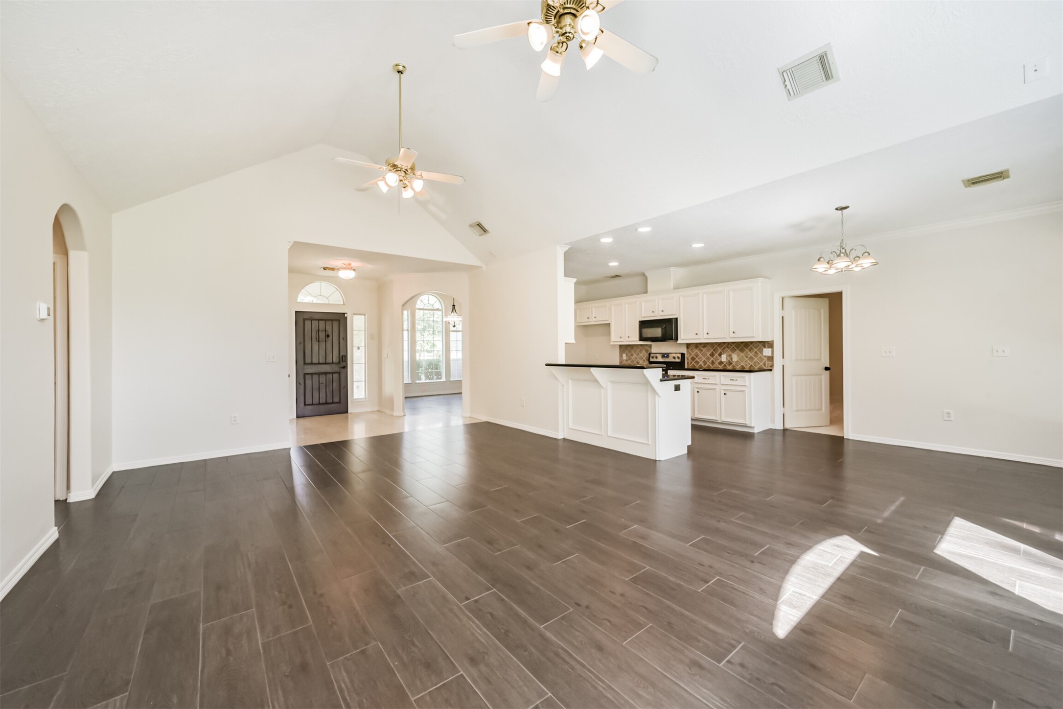 27322 Afton Way Huffman, TX 77336 - Photo 13 of 50 Open-concept design seamlessly connects the living room and kitchen, ideal for entertaining and everyday living.