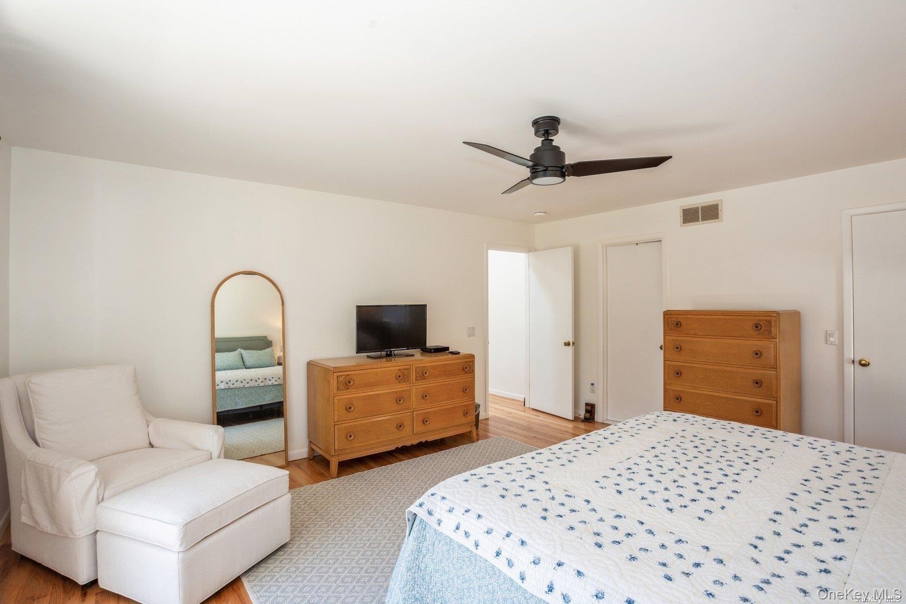70 Jagger Lane Westhampton, NY 11977 - Photo 12 of 20 a bedroom with a bed and a dresser