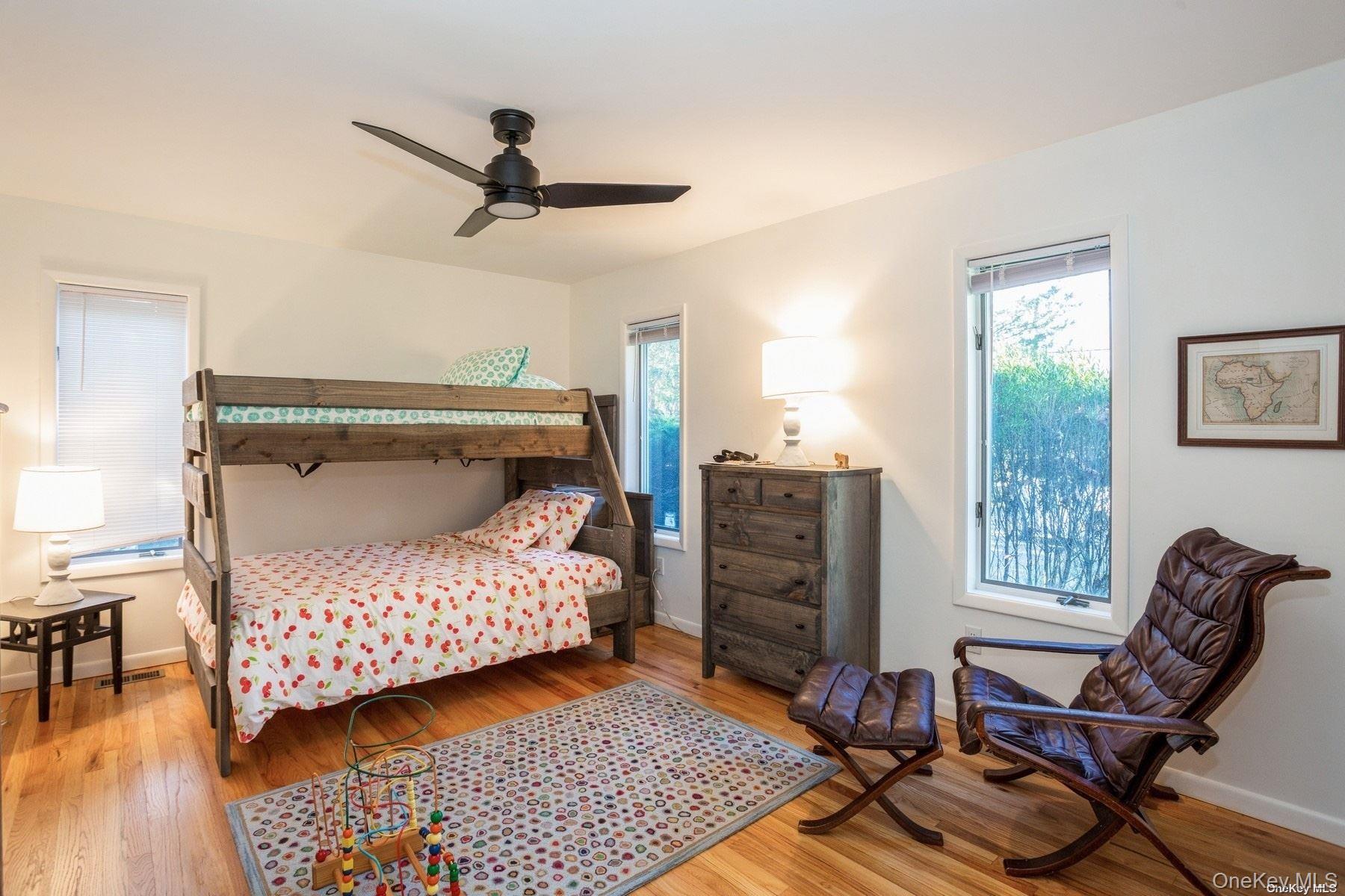 70 Jagger Lane Westhampton, NY 11977 - Photo 13 of 20 a bedroom with a bed and wooden floor