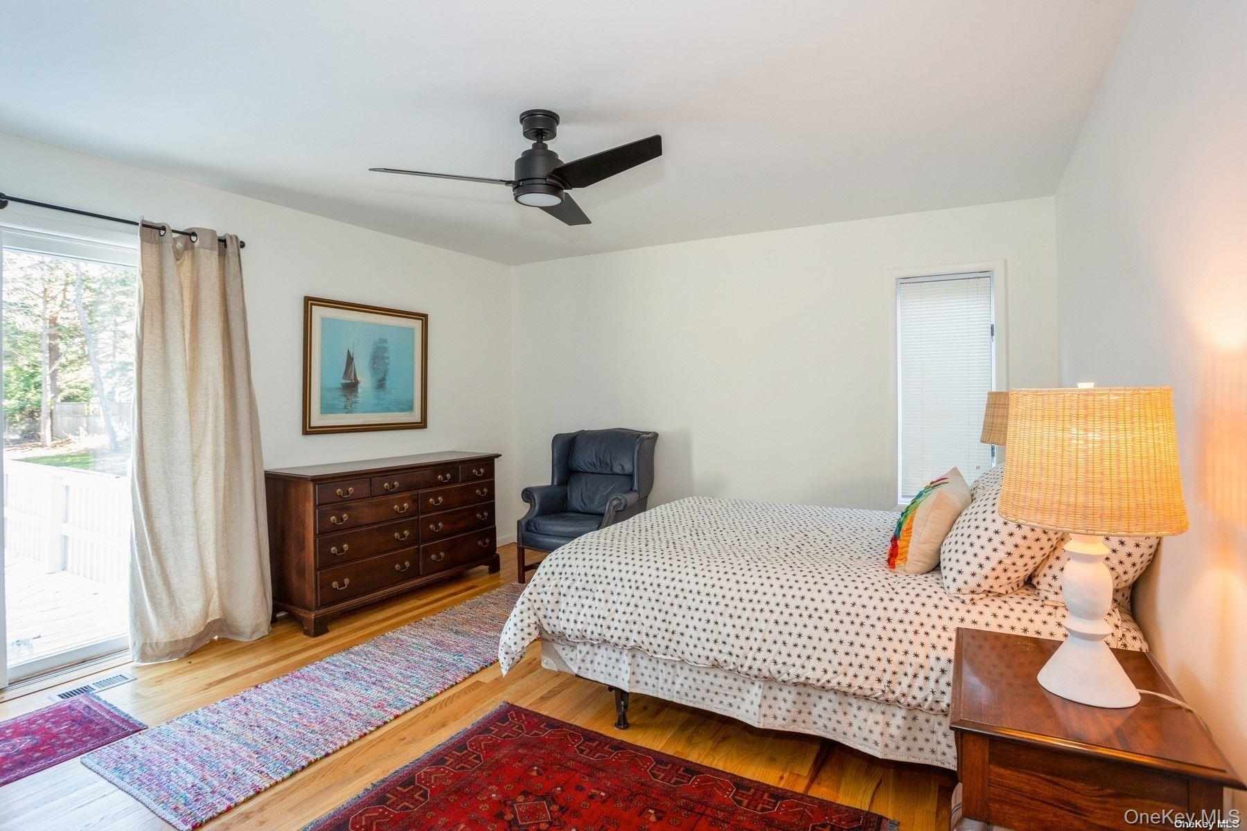 70 Jagger Lane Westhampton, NY 11977 - Photo 14 of 20 a bedroom with a bed and wooden floor