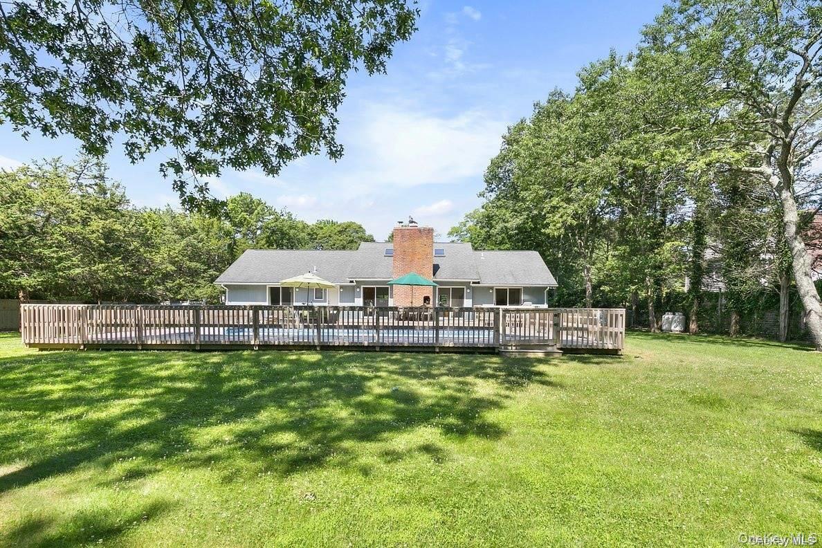 70 Jagger Lane Westhampton, NY 11977 - Photo 20 of 20 a view of a house with a big yard and large trees
