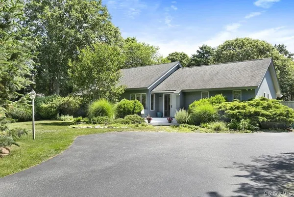 a aerial view of a house with a yard and potted plants