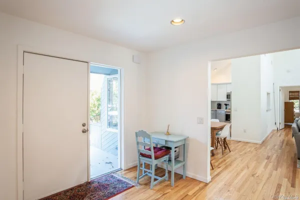 a view of a room with furniture and wooden floor