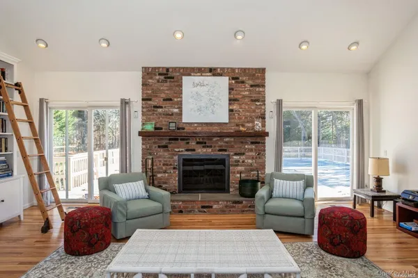 a living room with furniture a rug and a large window