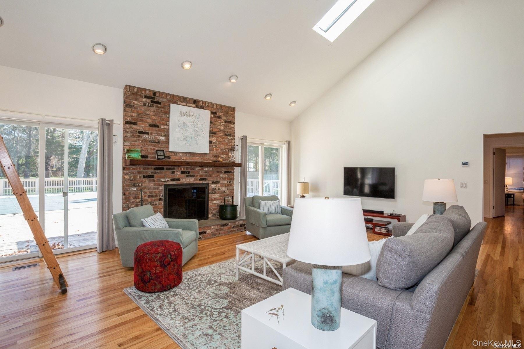 70 Jagger Lane Westhampton, NY 11977 - Photo 8 of 20 a living room with furniture and a fireplace