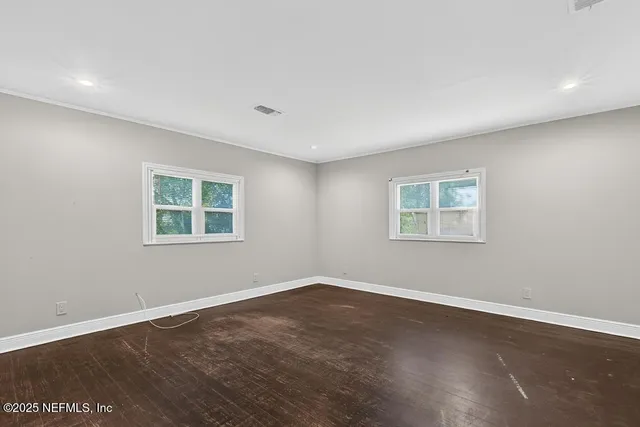 wooden floor in an empty room with a window