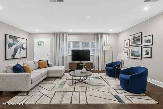 a living room with furniture and a flat screen tv