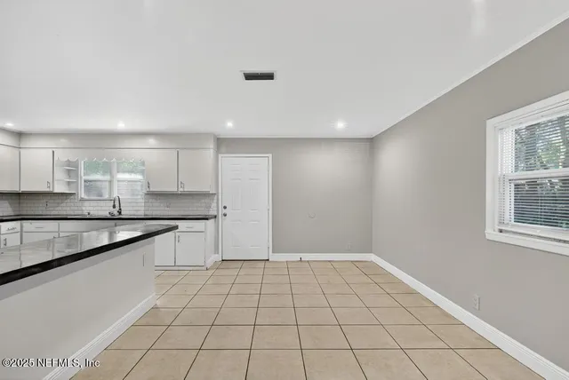 a view of a kitchen with a sink and cabinets