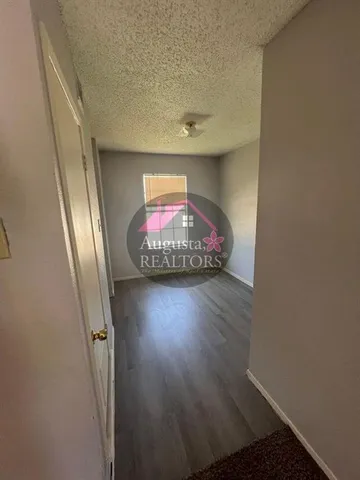 an entryway with wooden floor