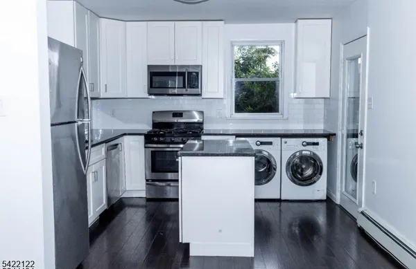 a kitchen with a refrigerator a stove a microwave and cabinets