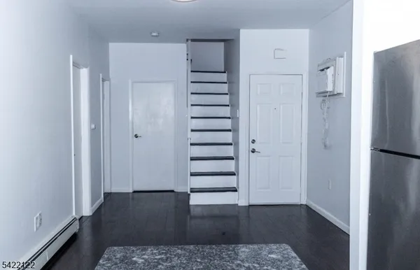 a view of a hallway with a wooden floor